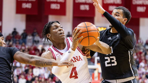 Dec 21, 2023; Bloomington, Indiana, USA; Indiana Hoosiers forward Anthony Walker (4) dribbles the ball as North Alabama Lions forward Tim Smith Jr. (23) defends in the first half at Simon Skjodt Assembly Hall. Mandatory Credit: Trevor Ruszkowski-USA TODAY Sports